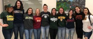 A row of senior girls in college t-shirts