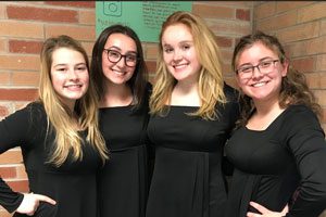 Choir members pose together in their formal dress