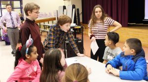 middle school students speaking to fourth-graders