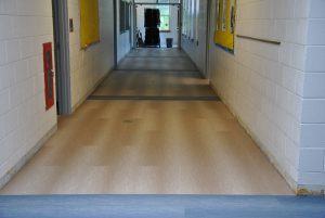View of replaced flooring in school hallway.