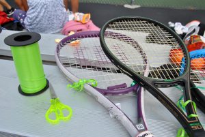 Close up of two tennis rackets with green ribbon
