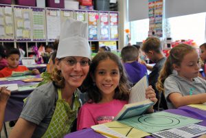 Teacher with student at book tasting
