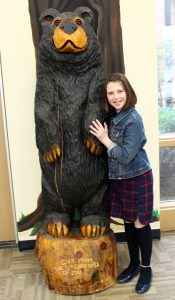 Fiona with wooden bear school mascot