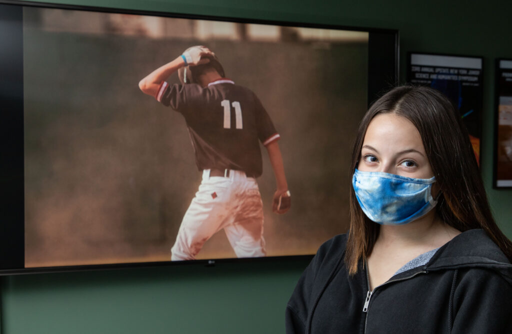 Superintendent's Artist of the Week Samantha Molinelli with one of her baseball photos on on Oct. 2, 2020.