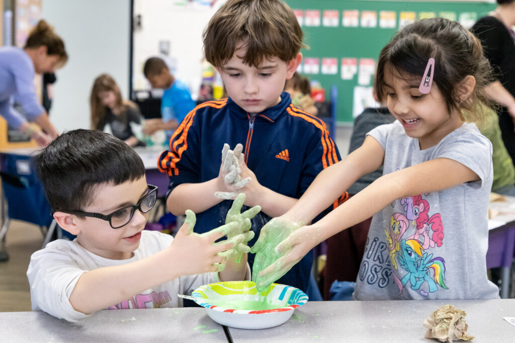 Pine Island Elementary School students play with Oobleck.